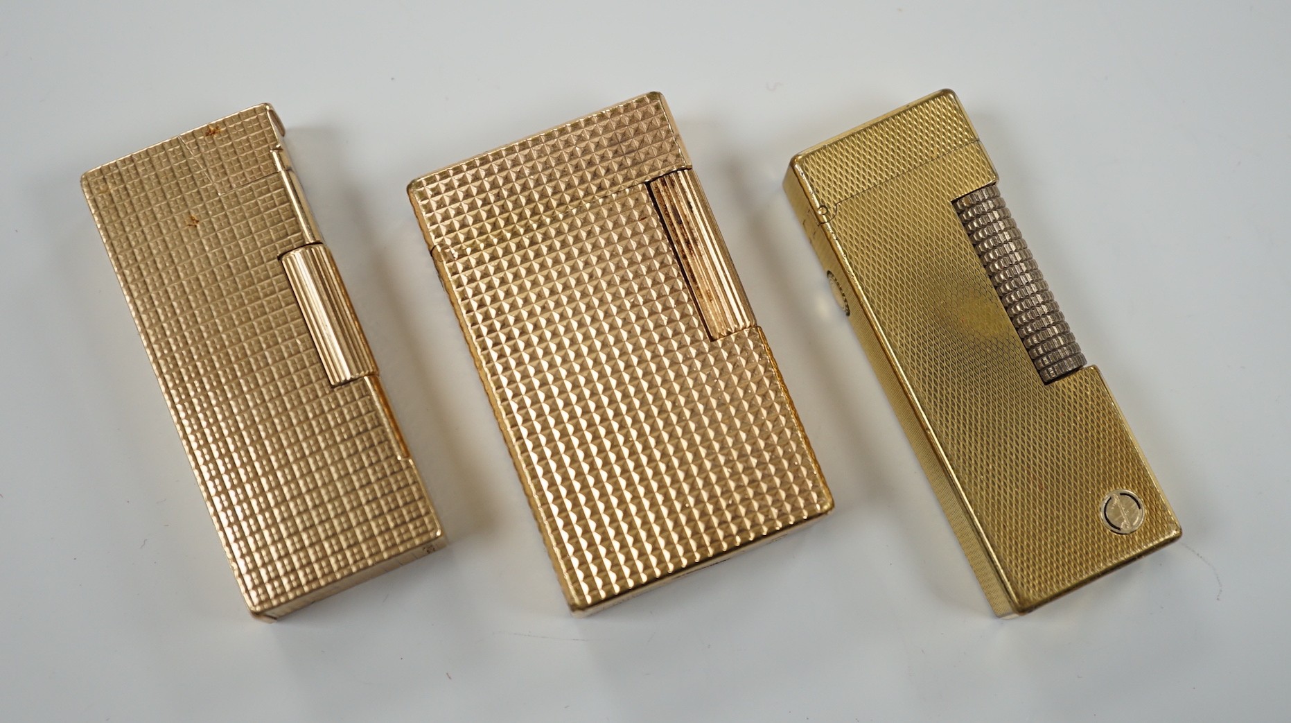 Three Dupont gilt metal lighters